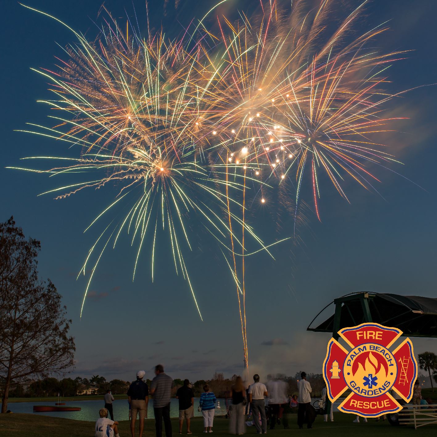 Palm Beach Gardens Fire Rescue. People watching fireworks over a body of water.