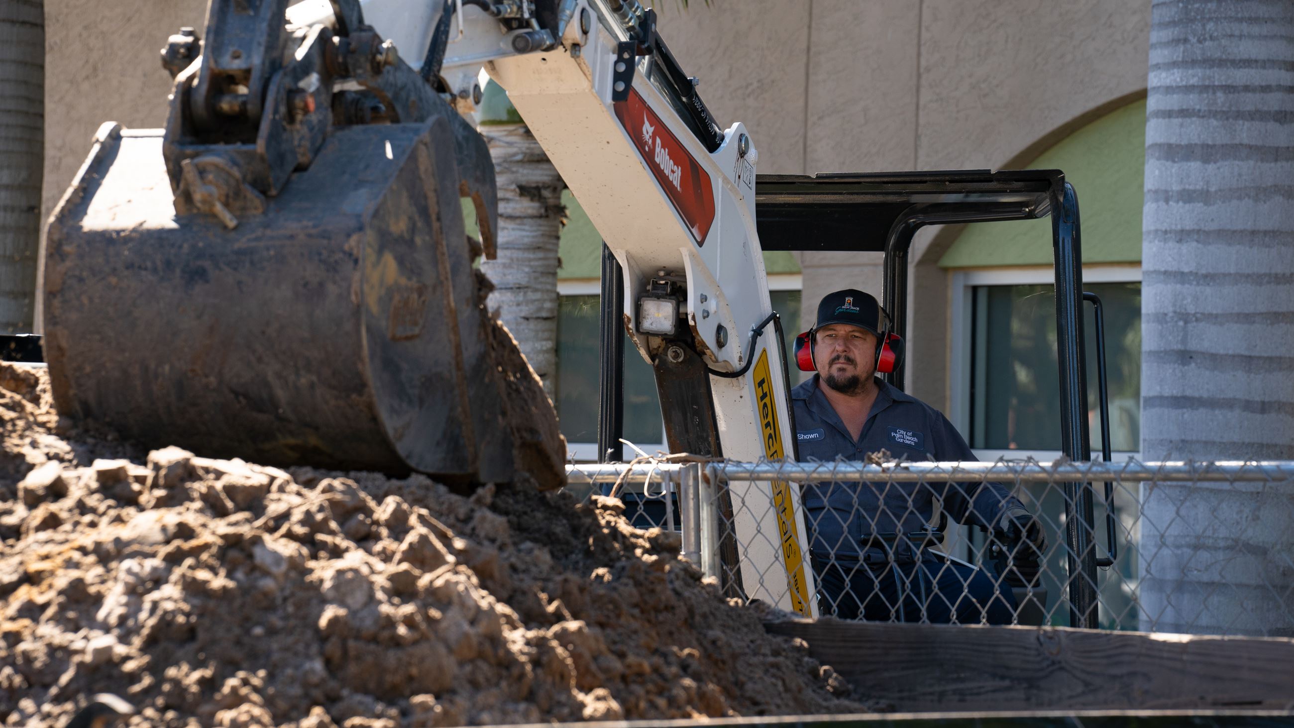 Employee operating front-end loader.