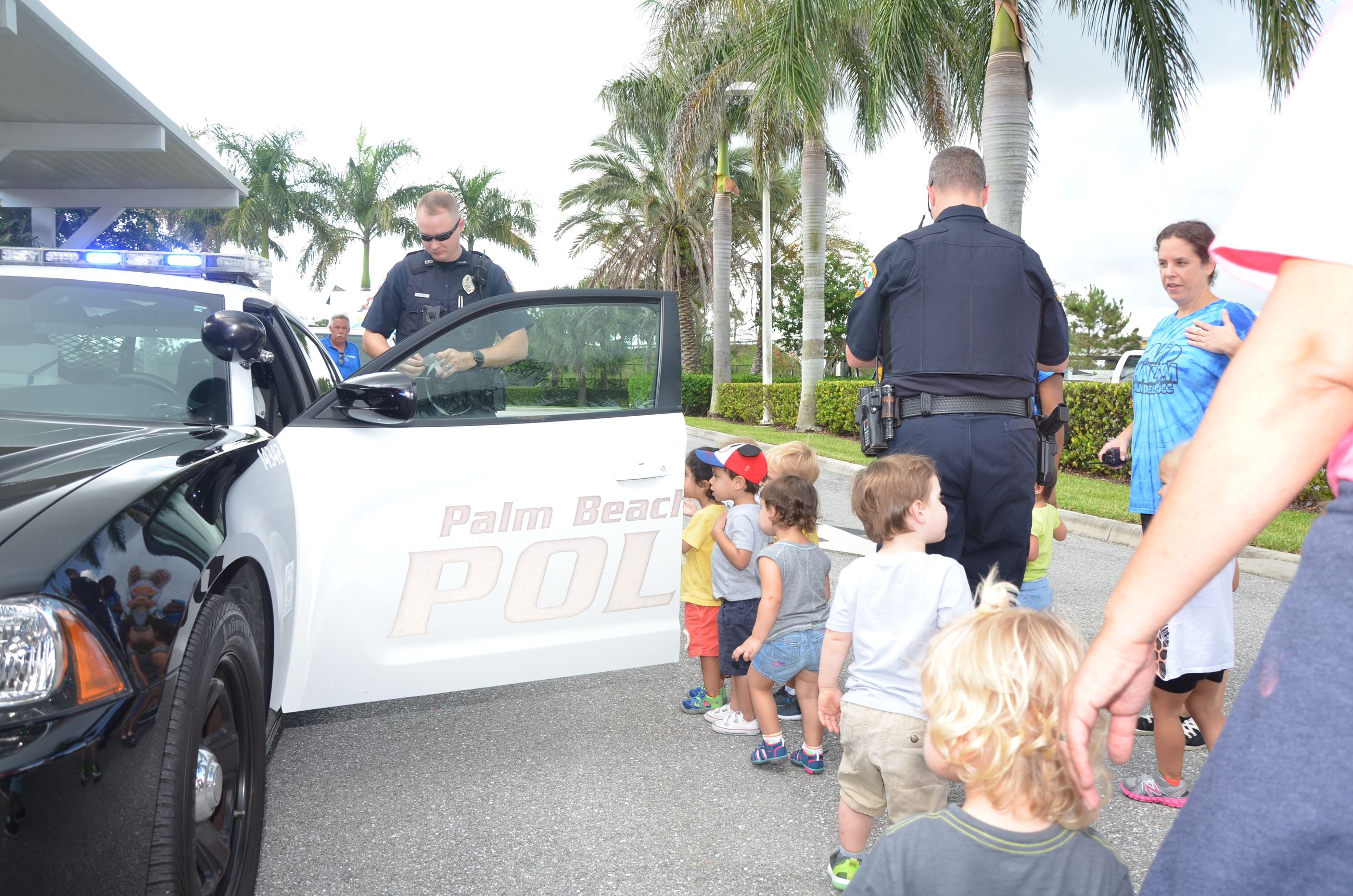 Police Officers Displaying Car to Children