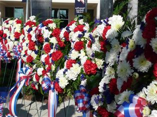 A row of red, white and blue floral wreaths